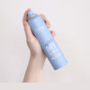holding Perfect Beauty Styling Dry Shampoo Volume Up with white background