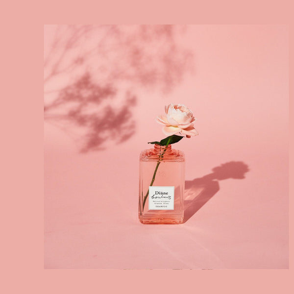 Rose stood in Bonheur Grasse Rose Shampoo bootle